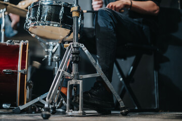 Focused image showcasing a musician's foot operating a drum pedal during rehearsal. Ideal for...