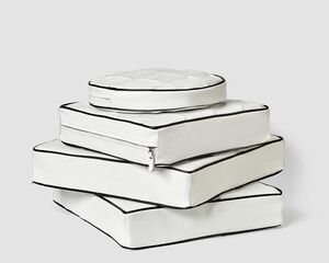 Stack of stylish white leather cushions with black piping on plain background