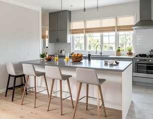 Fototapeta premium Modern kitchen island with gray countertop, wooden stools, and natural light. Fresh fruit and juice add a vibrant touch.