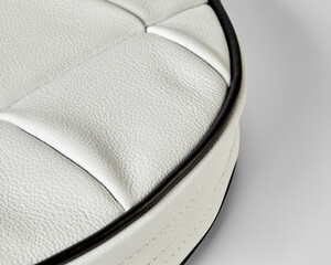 White leather upholstery with black piping creating luxurious and comfortable surface
