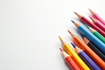 Scattered colorful pencils on pure white surface, pencils, wood, overhead