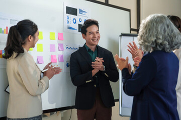 Diverse businesspeople clapping hands, congratulating their manager after successful presentation...