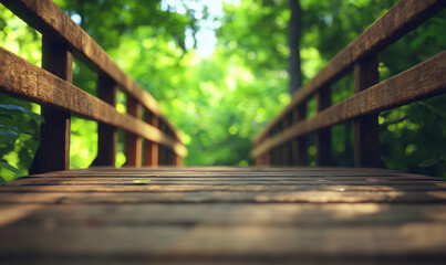 Fototapeta premium Wooden bridge leading through lush green forest with soft sunlight filtering.