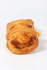 French-style pain aux raisins, a delicious pastry filled with raisins and pastry cream, shot in a studio setting