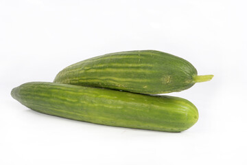 Whole cucumber on a white background, fresh and green with a smooth skin