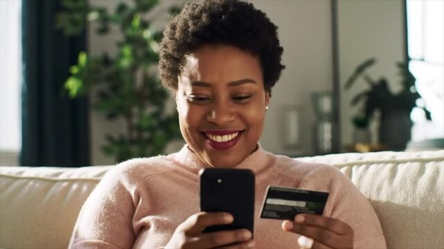 Home, credit card and black woman on sofa, smartphone and online payment with smile. Apartment, mobile user and African person on couch, cellphone and banking for transactions, ecommerce and savings