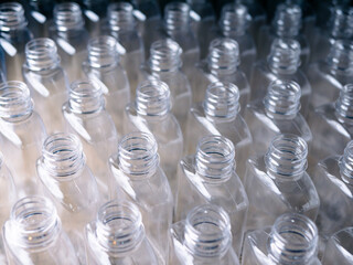 Close up Row of plastic drink water bottles for filling process.