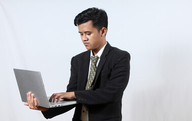 Asian man wearing black suit holding laptop working on negotiation with shareholder isolated on white background