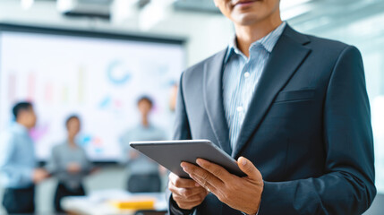Business meeting: male asian adult with tablet in modern office setting