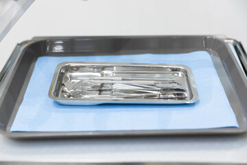A sterile tray showcasing various dental instruments neatly arranged for upcoming procedures,...