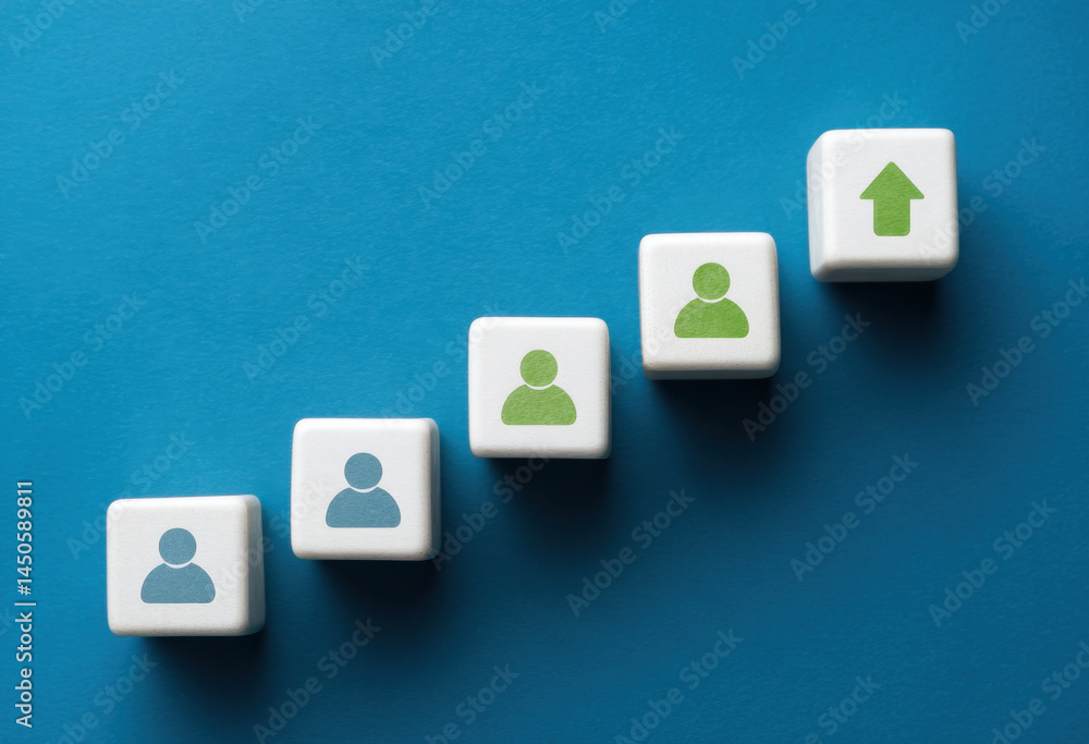Poster cubes featuring person icons illustrate progression in teamwork and collaboration skills in a corpor