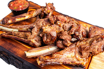 Grilled pork ribs served with zesty salsa on a wooden platter