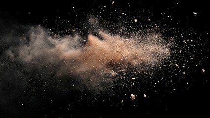 Explosion of brown dust particles on black backdrop.
