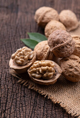 Cracked walnut on rustic old wooden table.