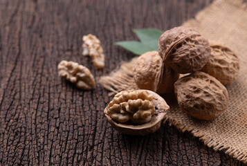 Cracked walnut on rustic old wooden table.