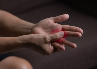 Trigger Finger, Senior woman's left hand massaging her ring finger, Suffering from pain, Close up...