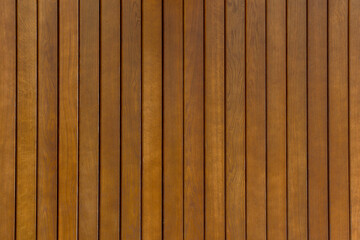 Fototapeta premium Fence of dark brown wooden planks with matte varnish coating. Wooden texture background.