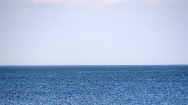 Sea view. Seascape. Sea landscape. Sea scenery. Blue sea surface, blue sky and skyline. Calm windless weather. Perspective. Nobody. Nature backdrop. Natural background