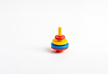 A stack of colorful plastic toys on a white surface.