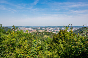 Elevated view of Besançon surrounded by trees, seen from the Via Francigena trail in France