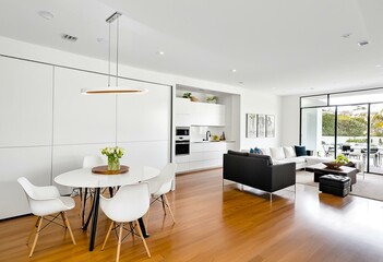 A dining room with a white table and chairs.