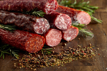 Smoked and dry cured sausages on a old wooden table.
