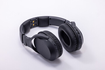 Modern Black Headphones on a White Surface for Listening to Music