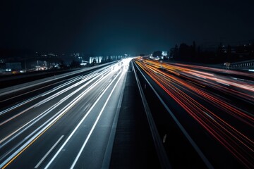 Night highway with streaks of light from cars.  Cityscape visible in the background