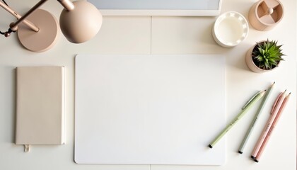 A white desk with a white pad of paper, a pen, a pencil, a plant, and a lamp