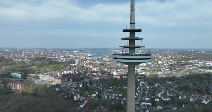 Telecommunications tower in Kiel, Germany, aerial drone video, skyline view.