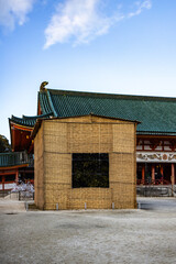 Traditional Japanese Building with Bamboo Structure and Blue Sky Background