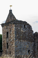 Ancient Stone Castle in Scotland Surrounded by Grass and Clear Sky