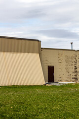 Abandoned Industrial Building With Rusted Door and Weathered Metal Cladding