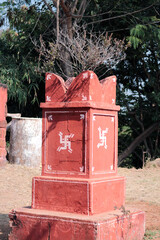 Traditional 'Tulsi Ghar' or 'Tulsi Stambha' decorated with a swastika in Rajasthan, India.