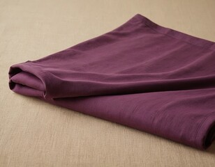 Elegant folded purple fabric showcasing rich texture and deep hue.