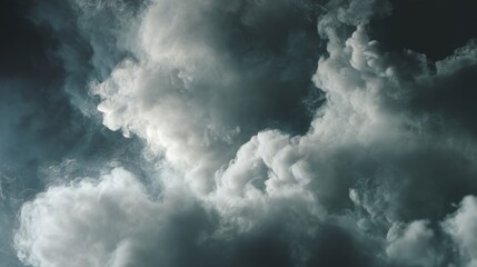 Obraz premium Abstract cloudscape. Moody grey and white smoke billows across a dark sky, creating a dramatic and atmospheric image.