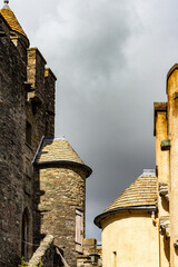 Old Stone Turrets on a Historic Building Under Overcast Skies