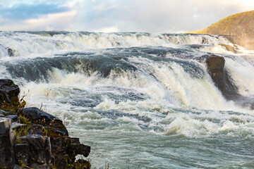 Majestic Flowing Waterfall Against a Vibrant Natural Landscape