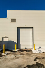 Industrial Warehouse Entrance With Snow and Shadowed Winter Scenery