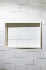 Empty Built-In Tile Shelf Recessed in a Wall of White Subway Tiles