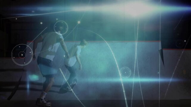 Two skateboarders riding halfpipe under bluish spotlight, adding dynamic tech light streaks