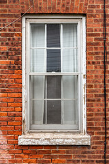Aged Wooden Window on Red Brick Wall Showing Vintage Architectural Charm