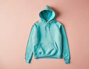 Trendy turquoise hoodie on a soft pastel background, perfect for casual and comfortable wear.