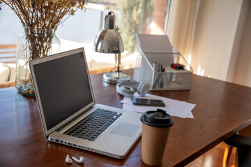 Cozy home workspace with laptop and coffee