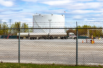 Industrial Truck at Secured Fuel Storage Facility With Barbed Wire Fence