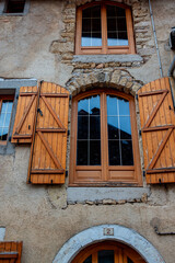 A peaceful and narrow street lined with traditional stone houses in the village of Mouthier-Haute-Pierre, along the Via Francigena in eastern France.