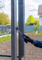 Man painting metal poles. Selective focus.