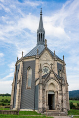 Fototapeta premium A striking neo-gothic style chapel located just outside the village of Ouhans in eastern France, surrounded by greenery and countryside