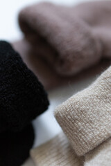 Close-up texture socks three pairs of warm socks on white background white brown black