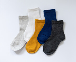 5 Pairs of children's socks in Blue, gray, mustard, yellow, white on a white background